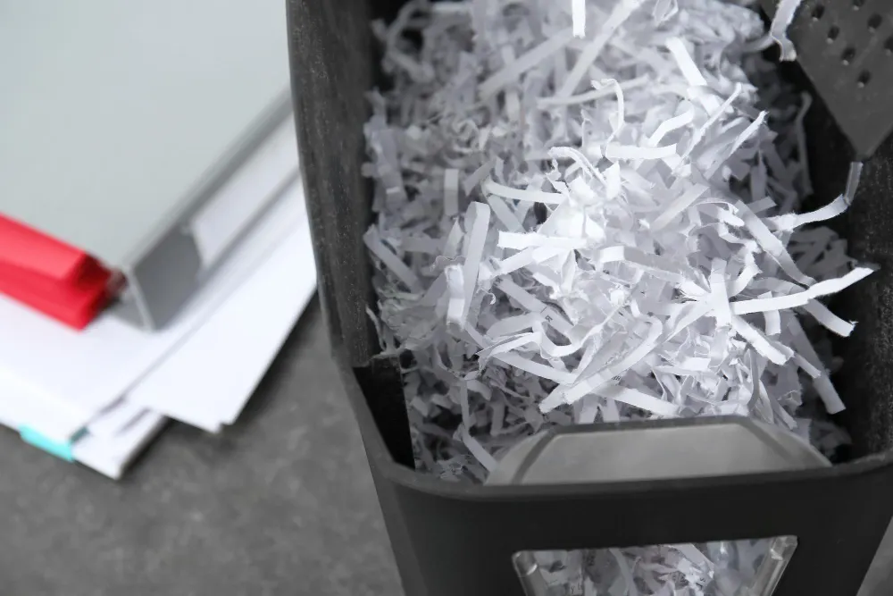 document-shredder-with-paper-shreds-table-closeup-kayman-vaults